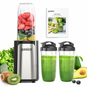 Blender with fruit ingredients and green smoothies.