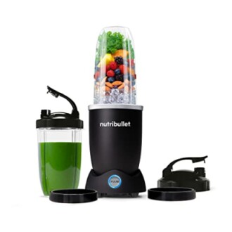 Nutribullet blender set with filled cup and green smoothie.