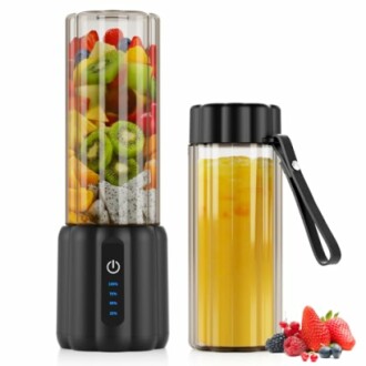 Portable blender with fruits and a bottle of juice.