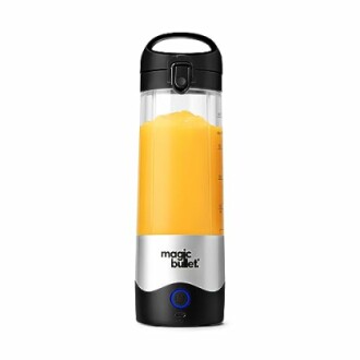 Portable blender with orange juice inside.